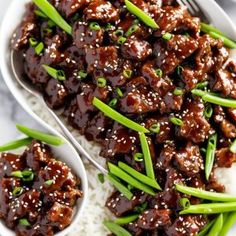 a white plate topped with meat and green onions next to chopsticks on top of rice