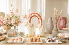 a table topped with lots of desserts and flowers