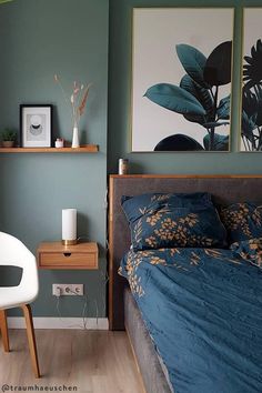 a bedroom with green walls and blue bedding in the corner, next to a white chair