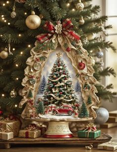 a christmas tree with presents under it on a table in front of a christmas tree