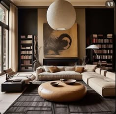 a living room filled with furniture and a large painting on the wall above it's fireplace