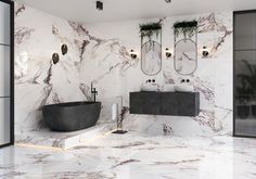 a bathroom with marble walls and flooring, two sinks and mirrors on the wall