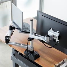 a laptop computer sitting on top of a wooden desk