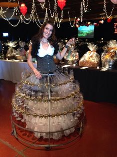 a woman standing in front of a display of glassware