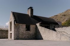 an old stone building with a steeple next to it