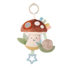 a stuffed toy with a mushroom on it's back and a snail hanging from the front