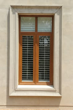 an open window with wooden shutters on the outside