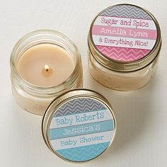 two small jars with labels on them sitting next to each other, one containing a candle and the other labeled baby shower