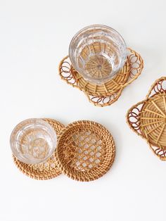 three wicker coasters with glass bowls on them