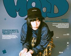 a woman sitting on top of a magazine cover wearing a hat and holding a skateboard