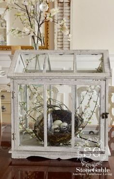 an old window is filled with flowers and other things to put in the centerpiece