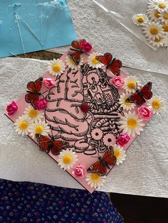 a piece of paper that has been decorated with flowers and butterflies on top of it