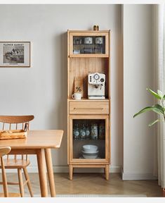 a wooden cabinet sitting next to a dining room table