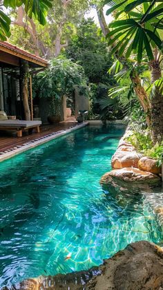 an outdoor swimming pool surrounded by trees and rocks