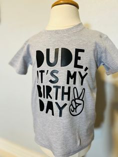 This trendy kids' birthday tee is the perfect way for your child to celebrate their birthday! *Designs are created using professional heat transfer material PLEASE SEE THE SIZING CHARTS for the measurements, and please consider comparing those measurements to a shirt that currently fits well. The recommended sizing for both our regular and premium shirts is S=5-7, M=8-10, L=11-12, and XL=13-14. For example, the S tends to fit most 5- and 6-year Olds, and smaller 7-year olds. And please keep in m 4th Birthday Shirts For Boys, 6th Birthday Boy Shirt, Birthday Shirts For Boys 6, Casual T-shirt With Funny Print For First Birthday, Birthday Designs, Boy Shirt