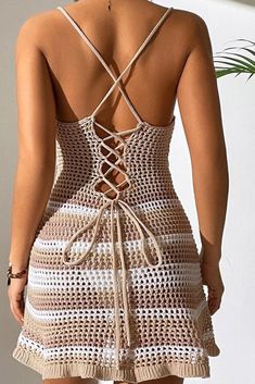 the back of a woman wearing a crochet dress