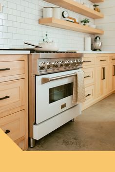 a white stove top oven sitting inside of a kitchen next to wooden cabinets and shelves