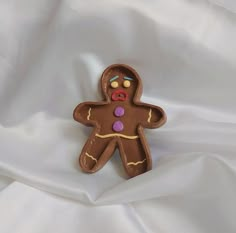 a cookie shaped like a ginger on white fabric