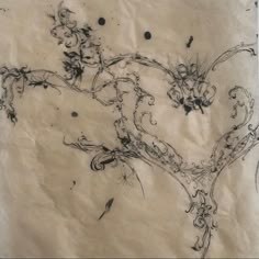 an old piece of paper with ink drawings on it