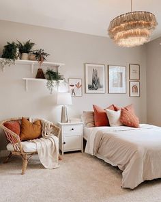 a bedroom with a bed, chair and pictures hanging on the wall above it's headboard