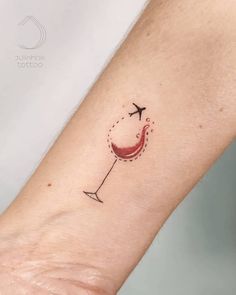 a small tattoo on the arm of a woman with an airplane flying over her head