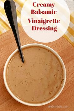 creamy balsamic vinaigette dressing in a white bowl with a black spoon