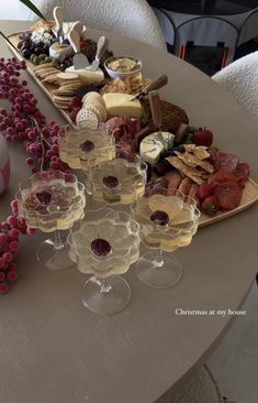 wine glasses and cheese platter on a table