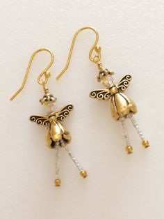 "Adorable little Christmas fairy angels made of Swarovski Crystals AB on 14k gold plated ear wires with gold plated little cone dress and delicate wings. Dangling legs are tiny iridescent glass  beads.  Sweet little fairies are about 1 3/4\" long and very lightweight.  What an adorable Christmas gift for someone special!" Sugar Skull Earrings, Angel Earrings, Gold Angel, Crystal Angels, Cute Christmas Gifts, Christmas Fairy, Flower Skull, Earrings Christmas, Skull Jewelry