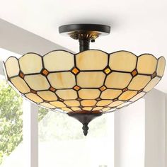 a semi - flush ceiling light fixture with stained glass shades in a living room setting