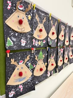 a bulletin board with christmas decorations and reindeer faces on it's sides, hanging from the wall