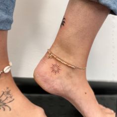 two people with tattoos on their feet and one has a small sun tattoo on the ankle