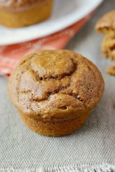 pumpkin appleauce muffins on a table with text overlay that reads, pumpkin appleauce muffins