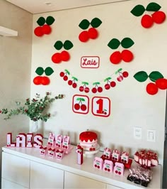 the table is decorated with cherries and candy for a birthday party or baby's first birthday