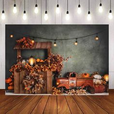 an old truck is parked in front of a backdrop with pumpkins and lights