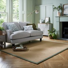 a living room scene with focus on the couch and coffee table in the foreground