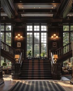 an elegant staircase leading up to the second floor in a large room with lots of windows