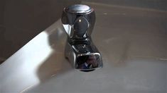 a chrome faucet sitting on top of a white sink