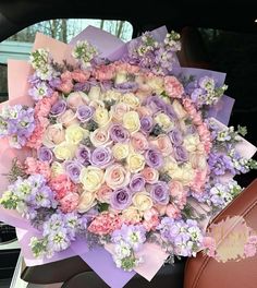 a bouquet of flowers sitting in the back of a car