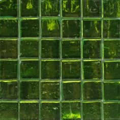 green glass tiles are arranged in rows