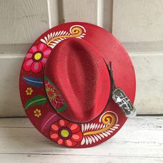 Stay stylish in this beautiful colorful hand painted straw hat, ideal for any sunny day occasion. Every single hat is hand painted uniquely which means there will never be another one like it. MADE IN MEXICO By: Mexican Artisans For: Women Size: Large (23.5") Color: red | multi Details: Material: Palm Straw Leather Band Inner elastic band Contact us for more details PLEASE READ BEFORE PURCHASE: The picture is an ACCURATE REPRESENTATION. Colors in the pictures may vary a little by effects of ligh Painted Hats, Sunny Day, Another One, Straw Hat, Leather Band, Elastic Band, Sunny Days, Dream Catcher, Straw