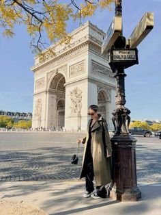 a man standing next to a lamp post