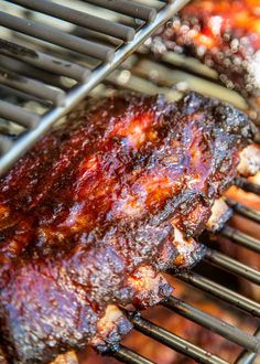 the ribs are being cooked on the grill