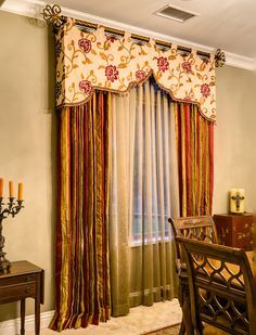 a dining room with curtains, table and candles on the side wall in front of it