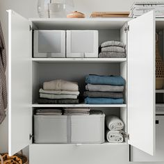 an organized closet with folded towels and other items