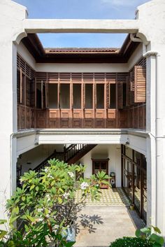 an apartment building with wooden balconies on the second floor