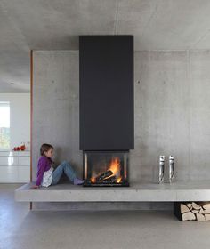 a person sitting in front of a fire place