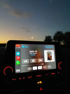 the dashboard of a car at night with an app on it's display screen