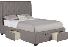 a bed with two drawers underneath it and a white pillow on the top of it