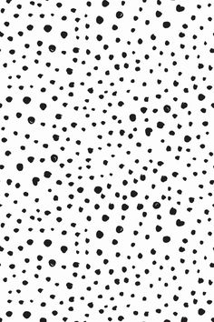 black and white polka dot pattern with small dots on the bottom right side of the image