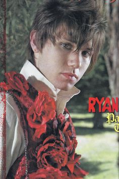 a magazine cover with a young man wearing a red flowered dress